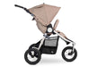 Side profile of bumbleride indie with 3  large air filled wheels, roomy basket and silver frame with sand canopy and seat. 