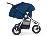 Fully reclined 3 wheeled bumbleride stroller with silver frame and maritime blue navy coloured canopy and seat. The leg rest is adjusted upward to enclose the look and feel of a bassinet. 