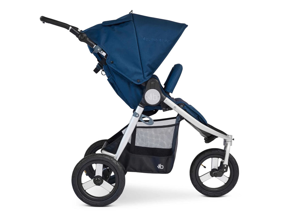 Side view of bumbleride indie stroller in maritime blue. Roomy basket, 3 air filled tires on silver frame.