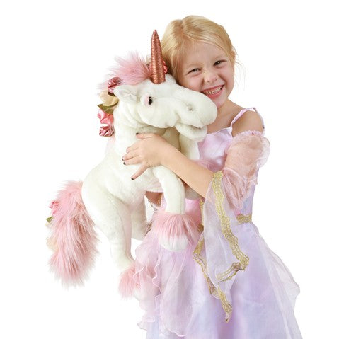 caption-Child hugging Folkmanis Unicorn puppet