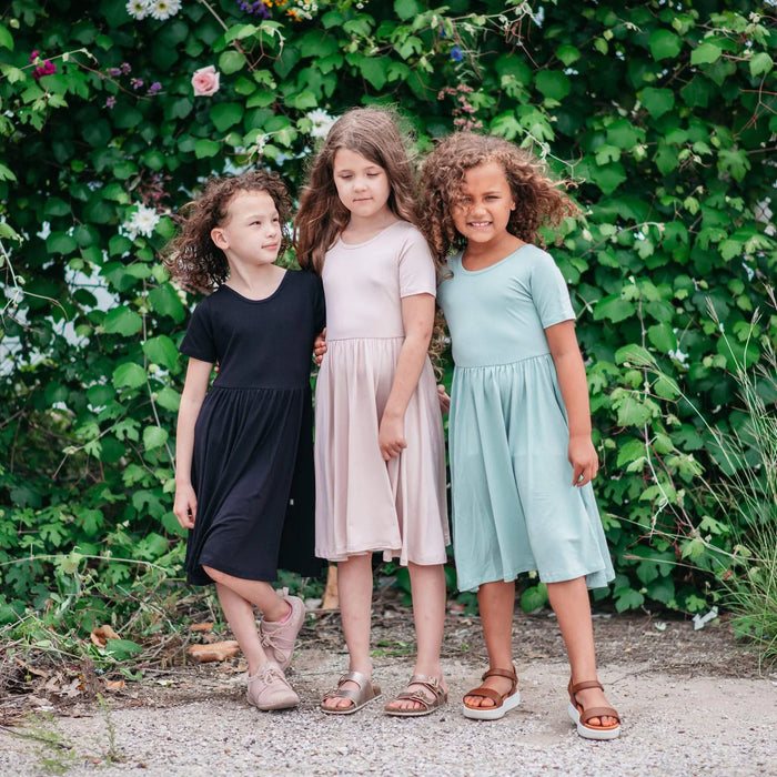 caption-Three children in Kyte Baby Twirl Dress