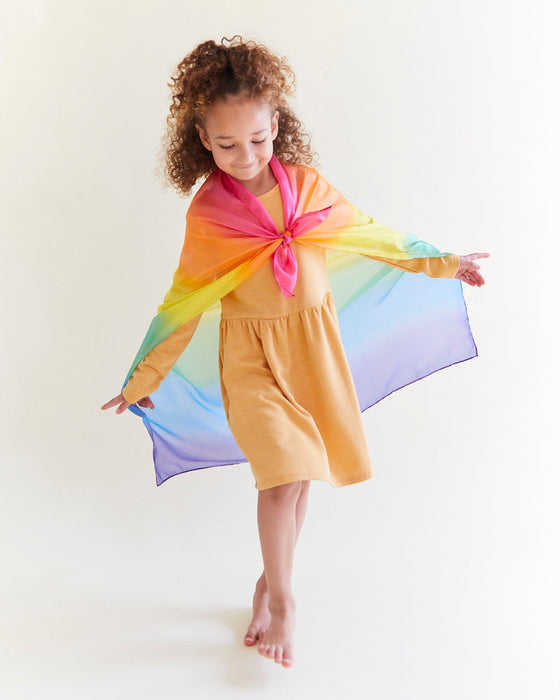 caption-Child playing with Rainbow Silk